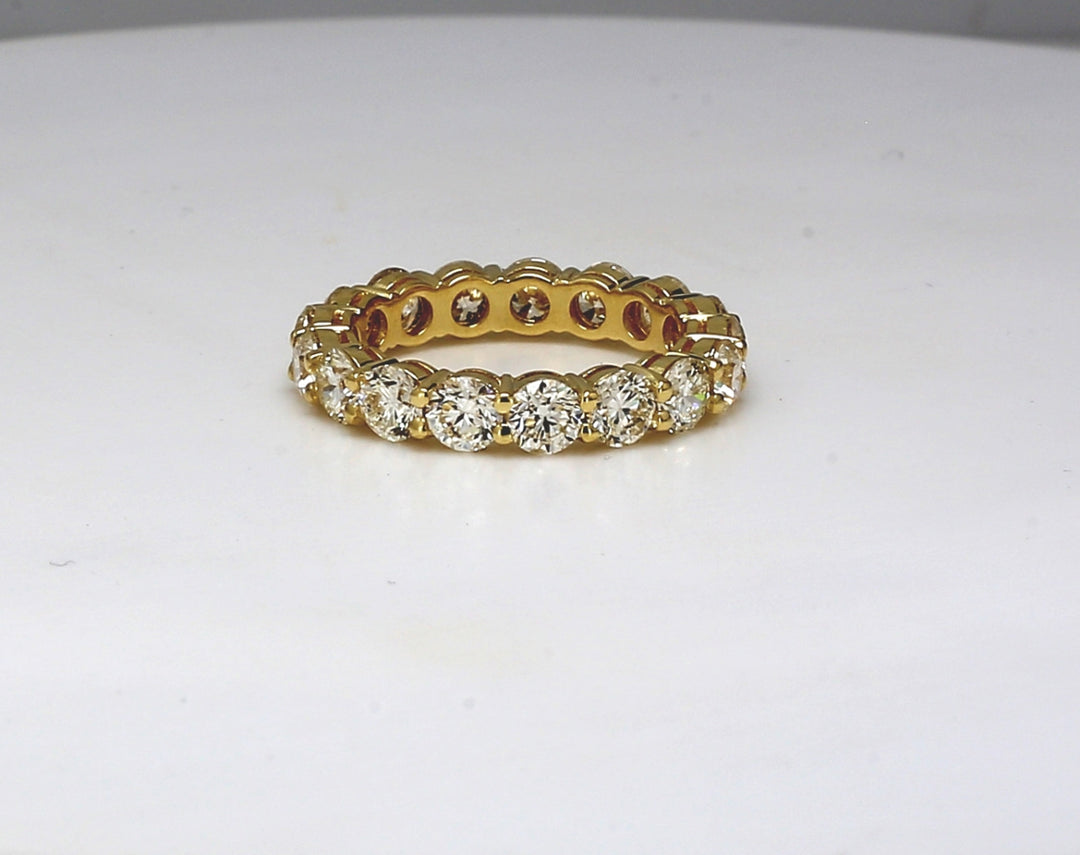 Eternity band in 18K YG with shared prong set (17) round diamonds.  D3.97ct.t.w.  Size 6.5