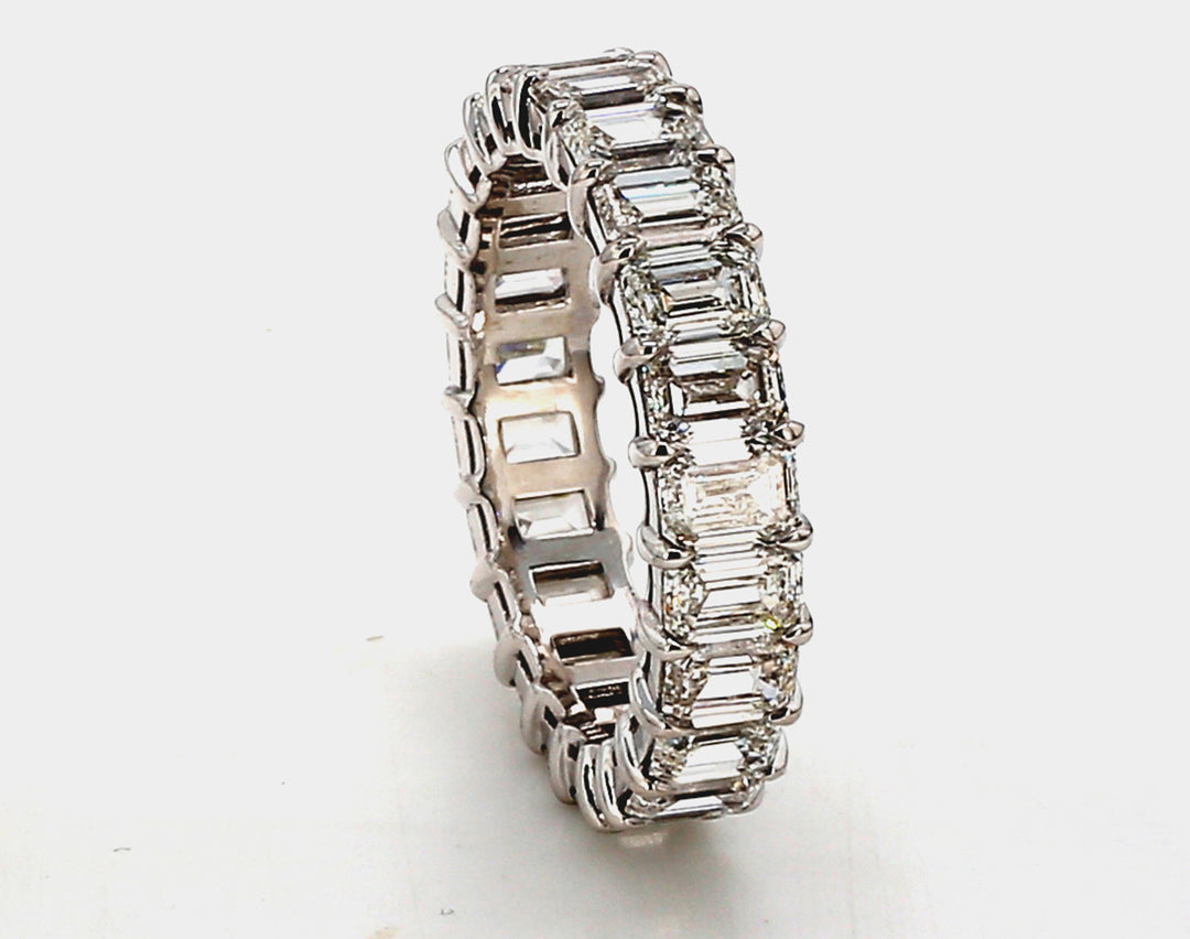 Eternity band in platinum with basket claw prong set (23) emerald cut diamonds.  D7.08ct.t.w.  Size 8.5