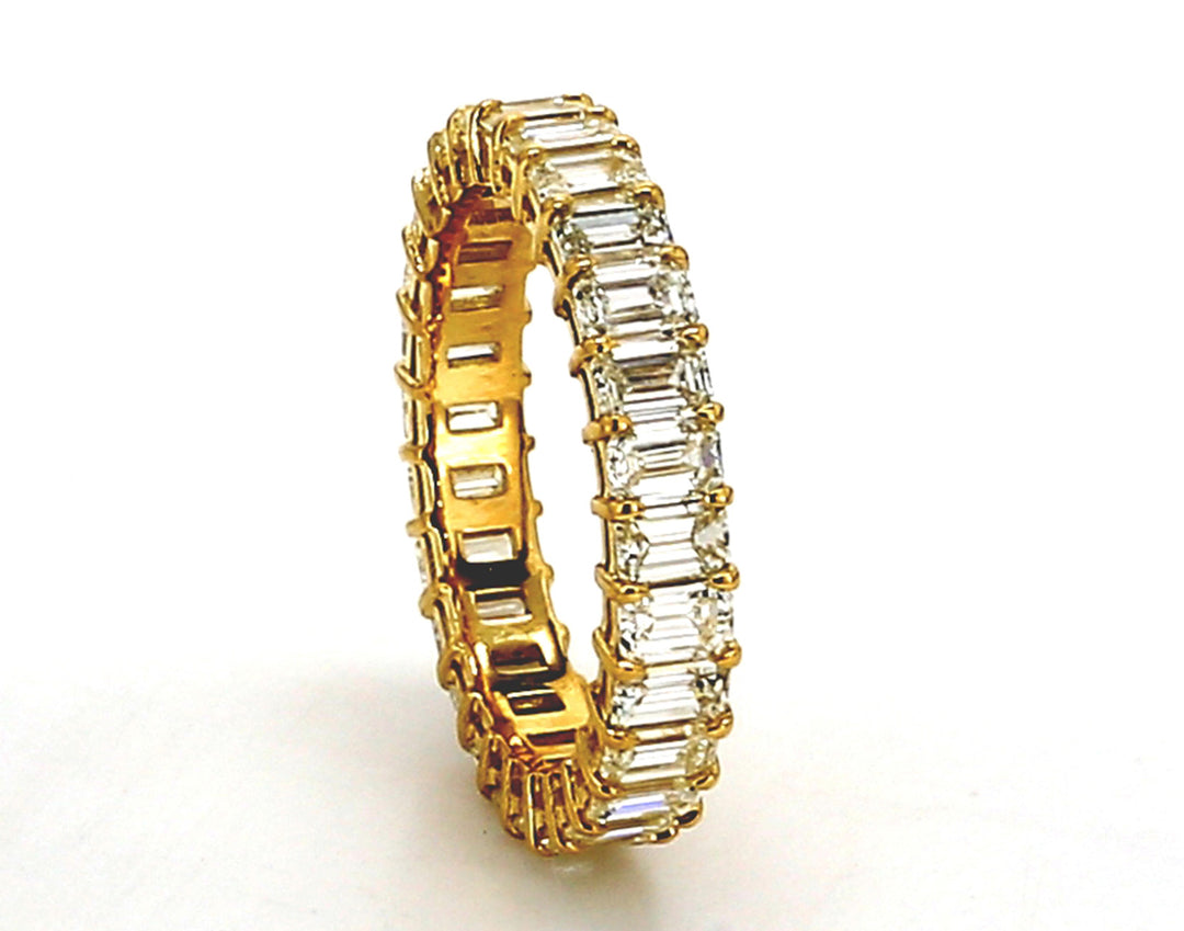 Eternity band in 18K YG with basket prong set (28) emerald cut diamonds.  D2.48ct.t.w.  Size 4.5