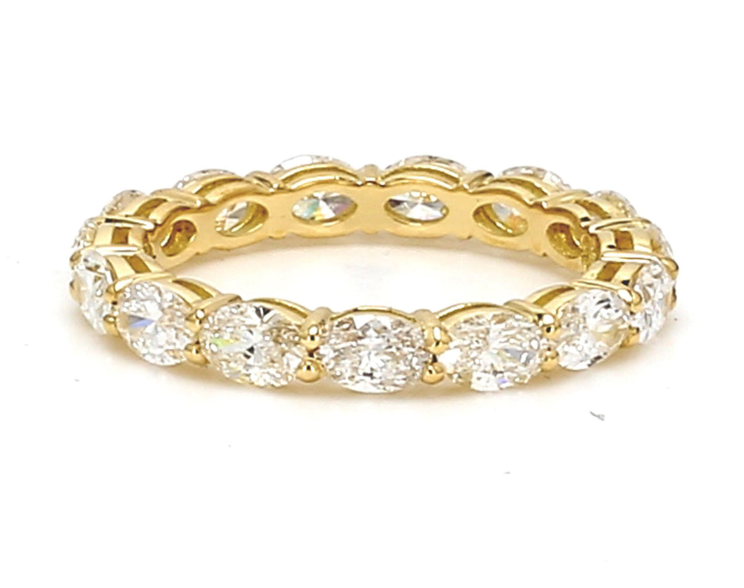 Eternity band east to west style in 18K YG with basket prong set (15) oval cut diamonds.  D2.03ct.t.w.  Size 5.5