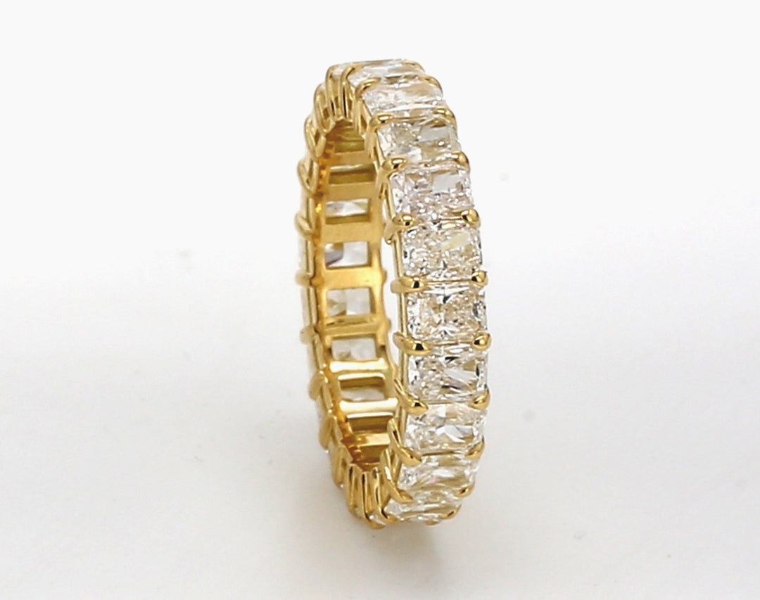 Eternity band in 18K YG with basket prong set (23) radiant cut diamonds.  D1.73ct.t.w.  Size 5