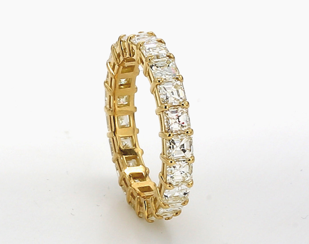 Eternity band in 18K YG with basket prong set (21) asscher cut diamonds.  D3.14ct.t.w.  Size 5.5