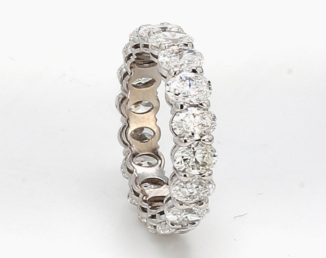 Eternity band in platinum with basket prong set (18) oval diamonds.  D3.37ct.t.w.  Size 4.25
