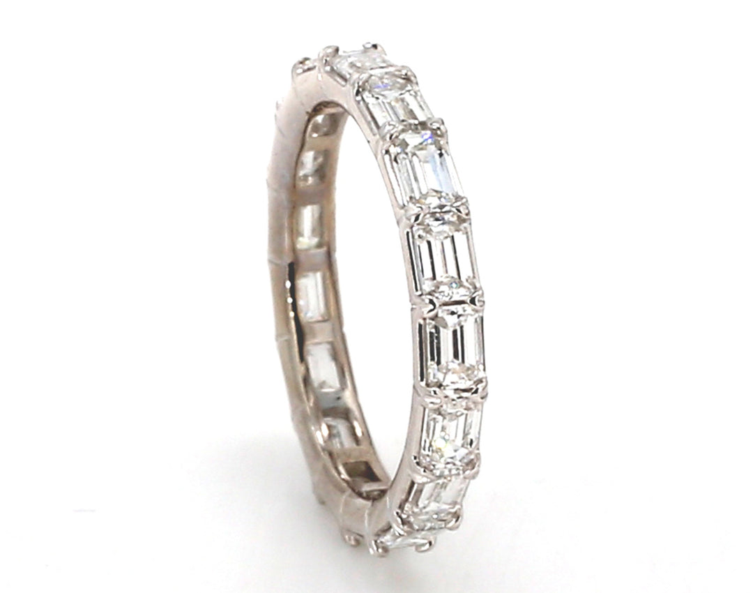 Eternity band east to west style in platinum with prong set (17) emerald cut diamonds.  D2.35ct.t.w.  Size 6