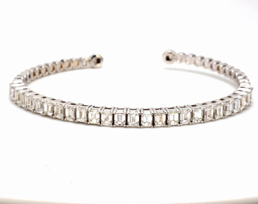 Open cuff bangle in 18K WG with basket prong set (26) emerald cut diamonds.  D3.89ct.t.w.