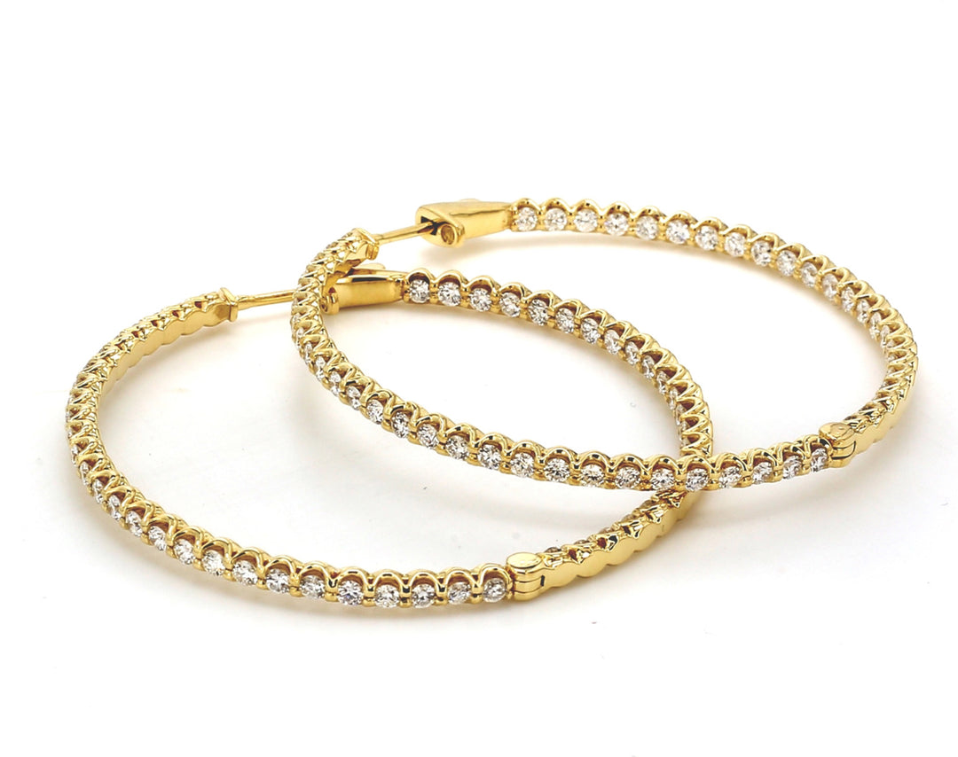 1.80""  Inside out hoop earrings in 18K YG with U-prong set (100) round diamonds.  D3.10ct.t.w.