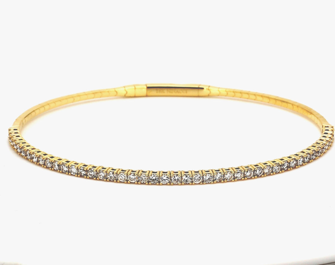 Flexible bangle in 18K YG with pre-set round diamonds.  D1.01ct.t.w.