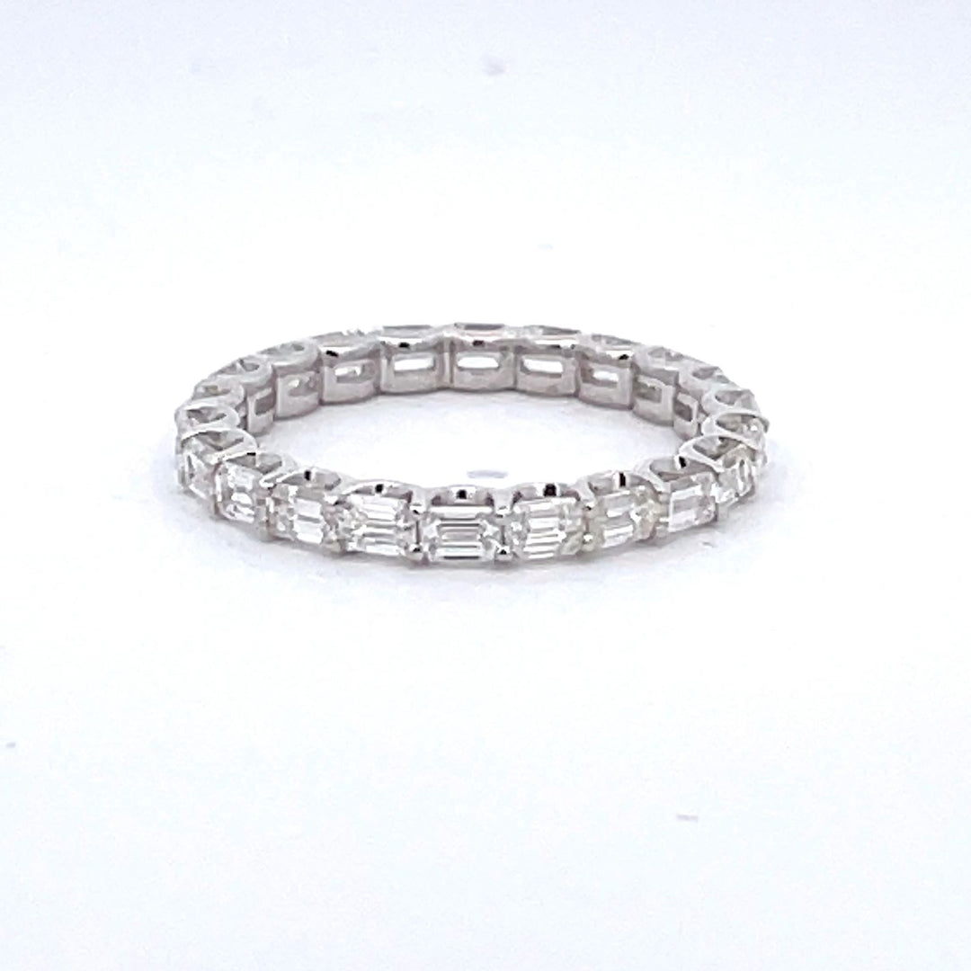 Eternity band east to west style in 18K WG with basket U-prong set (22) emerald cut diamonds.  D1.86ct.t.w.  Size 6.5