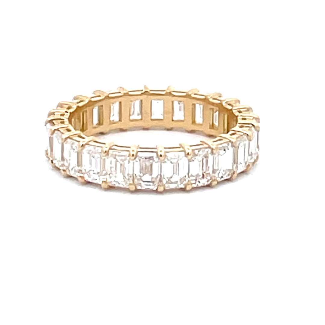 Eternity band in 18K YG with basket prong set (24)  emerald cut diamonds.  D3.27ct.t.w.  Size 5