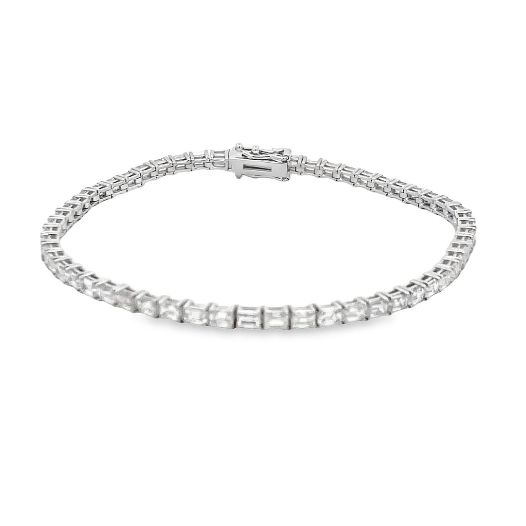 Tennis bracelet east to west style in 18K WG with basket prong set (56) emerald cut diamonds.  D5.70ct.t.w.
