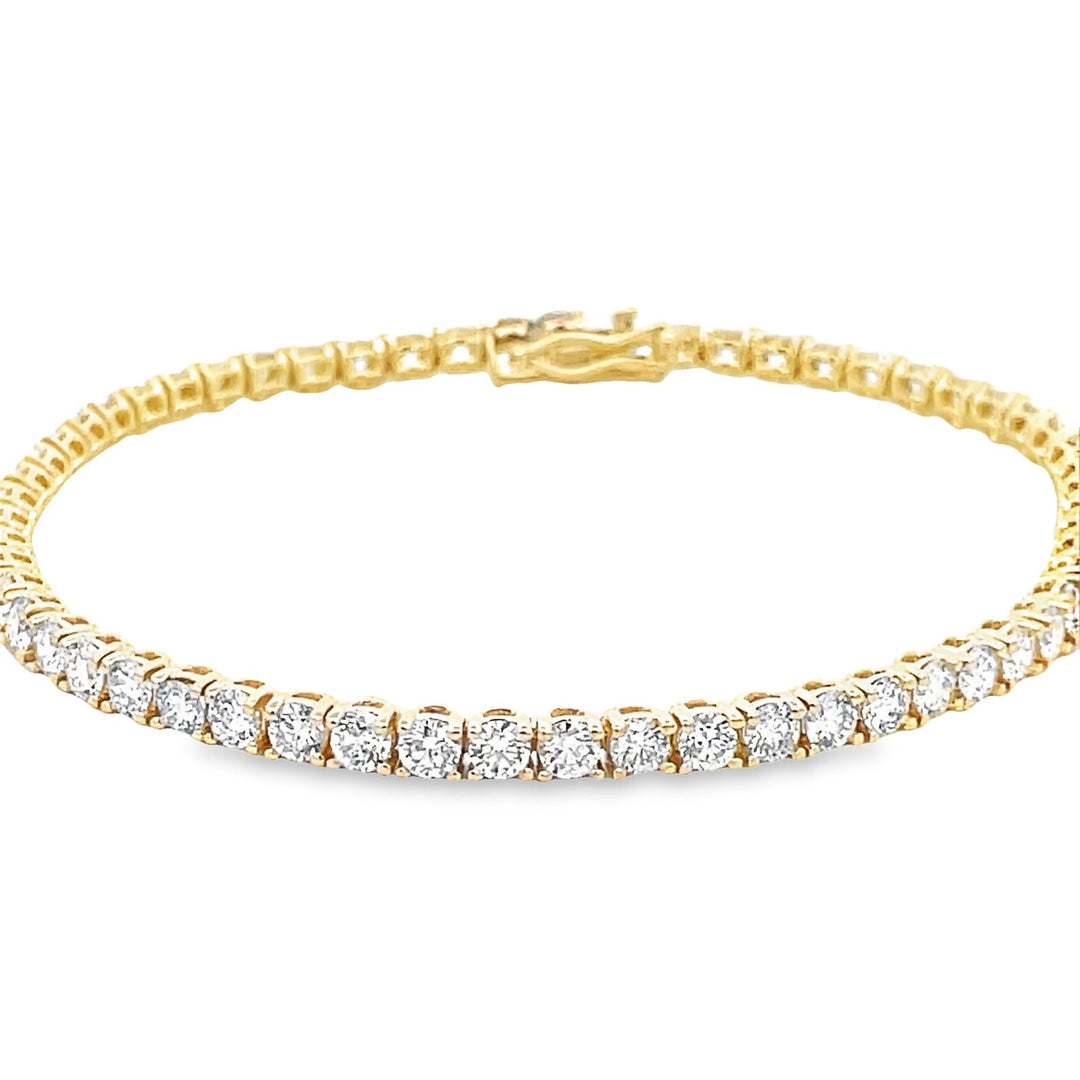 7"" Tennis bracelet in 18K YG with open basket prong set (58) round diamonds.  D5.15ct.t.w.